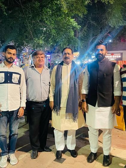 A group photo with political associates and security personnel during an evening outing. My work often extends beyond formal meetings.