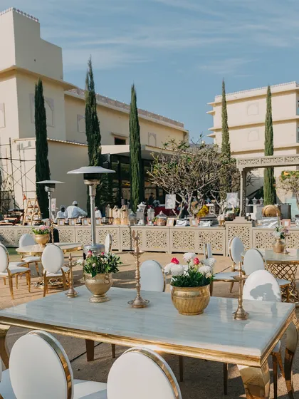 A glimpse of an elegant outdoor lunch setup, with marble-top tables and chic white chairs. I ensure every meal and every gathering has a beautiful and comfortable setting.