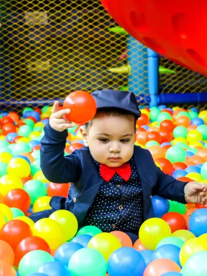 Even the littlest ones have a blast. This dapper young guest is enjoying our massive, clean, and safe ball pit, perfect for toddlers to explore and play in.
