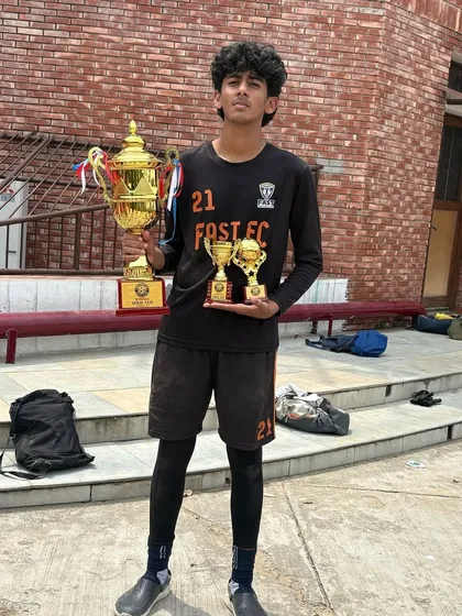 Tanay Rao with his collection of trophies, including the Best Goalkeeper award and the U15 GYL championship trophy.