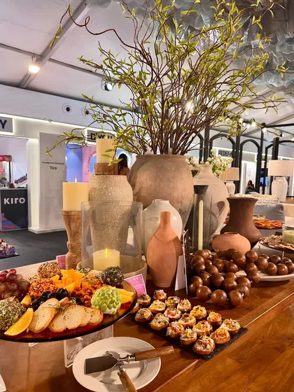 The full grazing table at the Pottery Barn event, featuring a beautiful arrangement of food, candles, and rustic pottery.