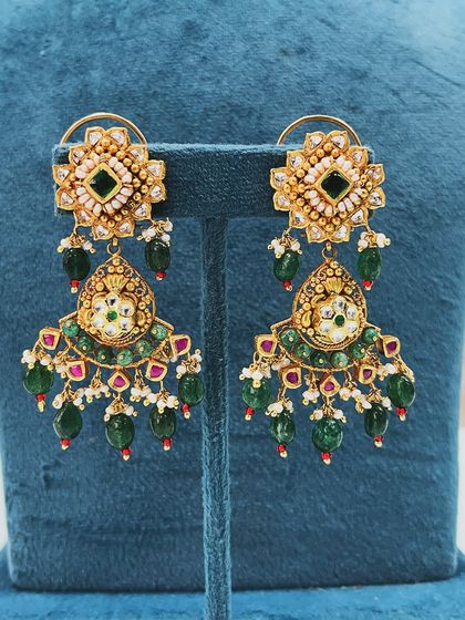 A close-up of the stunning earrings we created as part of a larger upcycle. By combining various old gold pieces, we were able to design these intricate, heavy earrings that perfectly match the new necklace.