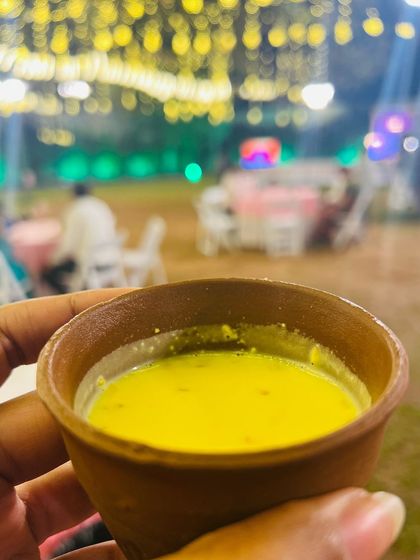 A warm cup of Badam Milk served in a traditional kulhad (earthen cup). This is a comforting and classic beverage, perfect for evening or winter events.