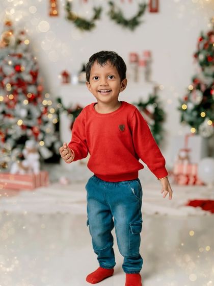A happy dance among the Christmas trees. These sessions are filled with playful energy, resulting in genuine smiles and festive portraits.