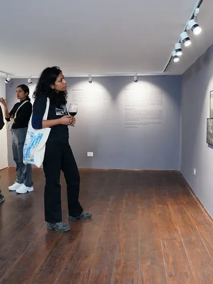 A visitor enjoying the gallery atmosphere during the opening night of "Dreams of a Summer Past."