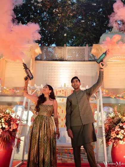 The couple makes a fun entry at their Mehendi party with color smoke guns. We love adding playful and modern twists to traditional ceremonies.