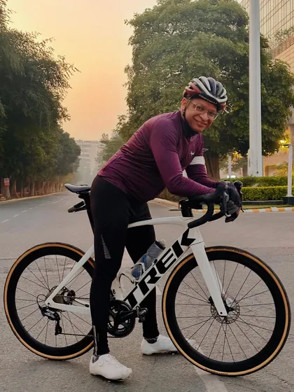 A member with his white Trek bike, ready for an early morning ride.