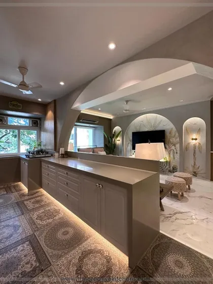 We brought boho vibes to this open-plan kitchen with a stunning European membrane finish and exquisite routed shutters. The under-cabinet lighting adds a warm glow, highlighting the unique patterned floor.