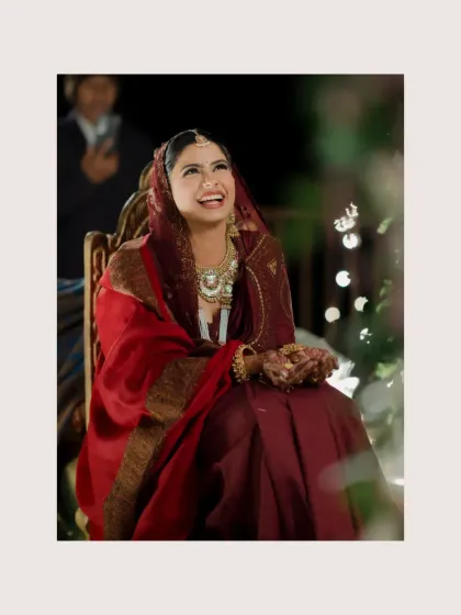 A candid shot of the bride laughing with joy during one of the wedding rituals.