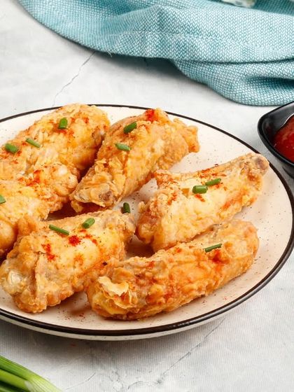 A close-up of our perfectly fried chicken wings, showcasing their crispy texture. A must-try for anyone craving a simple yet delicious starter.