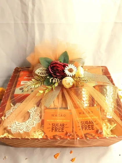 A beautifully wrapped Diwali hamper, ready to be gifted. This one features sugar-free chocolates, copper glasses, and other healthy treats, showing that festive indulgence can also be mindful.