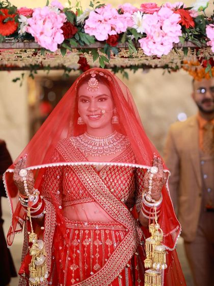 A happy bride peeking through her veil. Her smile is so bright and full of joy.