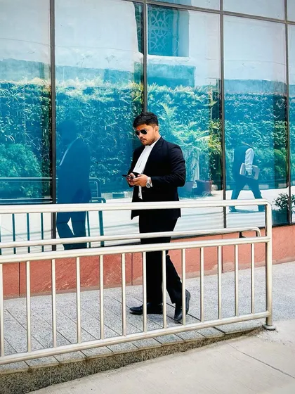 Walking along the exterior of a court building. Confidence is an accessory earned through experience and success.