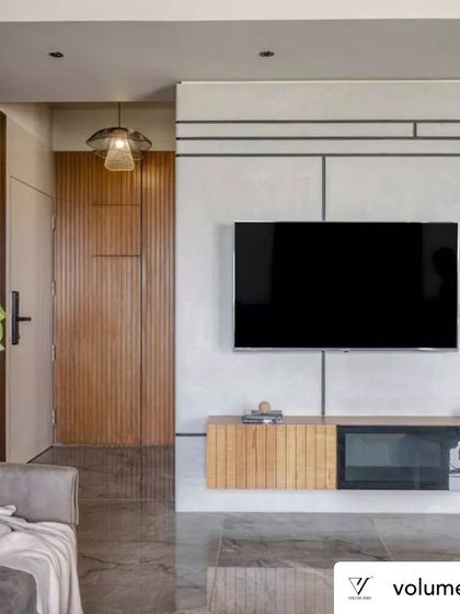 The TV and media unit in Rustic Reverie was custom designed for both form and function. The floating console with fluted wood details keeps the space feeling light, while the asymmetrical shelving and geometric wall lines add visual interest without creating clutter.