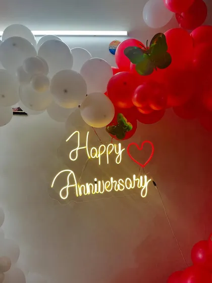 A detailed shot of the 'Happy Anniversary' neon sign, which adds a professional and personal touch.