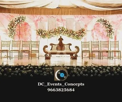 A wide shot of the pink marble wedding stage before the festivities begin. This view highlights the full scale of the decor, from the floral arrangements to the seating plan, all designed to work in harmony.
