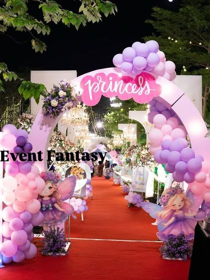 The entrance to Varnnika's fairyland at night, with a fairy performer creating a magical bubble show.