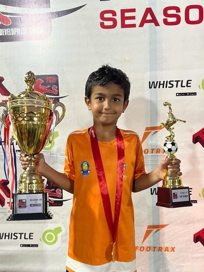 Another one of our U7 champions with his trophies.