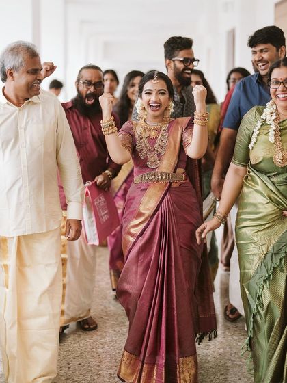 The bride's grand entrance, surrounded by the joyous energy of her family. Namritha's excitement is palpable as she makes her way to the ceremony.