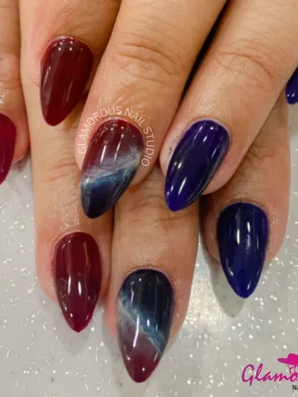 A dark and dramatic marble effect. We blended a deep wine red with a cosmic blue and white to create this smoky, galaxy-like design. This is for the client who loves a bold and mysterious look.