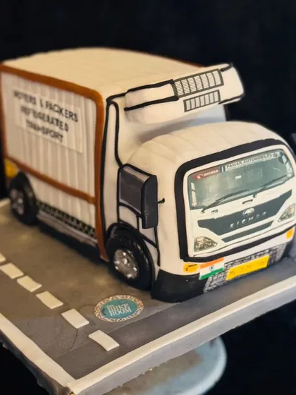 A full view of the custom Eicher truck cake. This 3D sculpted cake was made to celebrate a transport business, showing how I can turn a professional passion into a sweet reality.
