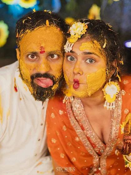 This is what pure, unadulterated fun looks like. I love capturing the real masti of a Haldi ceremony, and this goofy, candid moment shows a couple completely lost in the joy of the ritual, no fake posing needed.
