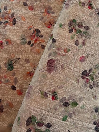 A closer look at our printed and embroidered cotton fabric. The combination of chikankari-style embroidery and a soft floral print creates a unique and beautiful texture.
