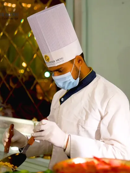 One of my chefs, focused and professional, stir-frying a dish at a live station, ensuring every plate is cooked to perfection.