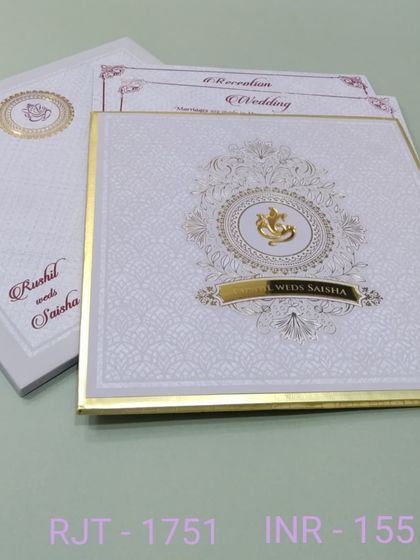 This classic white invitation is adorned with a beautiful Ganesha motif inside an ornate gold circle. The design is clean, elegant, and perfect for a blessed beginning.