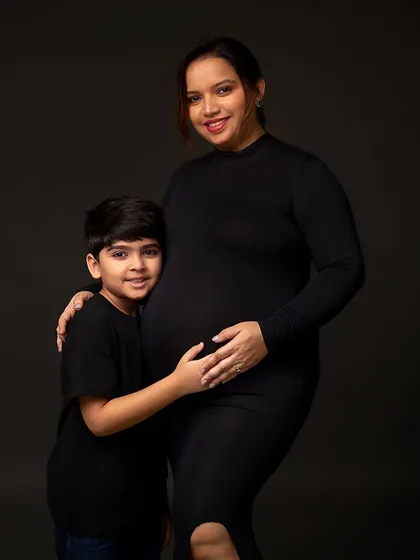 A classic portrait of mother and son, both looking at the camera. This shot is a beautiful record of this special time in their family's life.