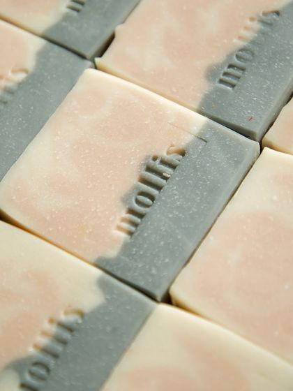 A grid of freshly stamped 'Aqua' bars, each with a slightly different pattern.
