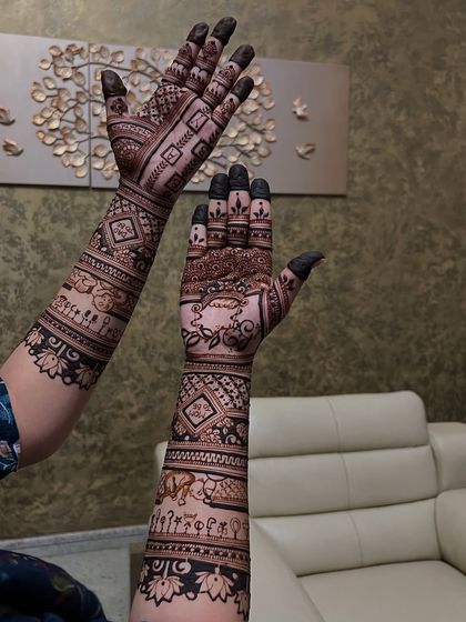 A different view of the detailed baby shower mehendi, showing the intricate patterns and storytelling elements from another angle.