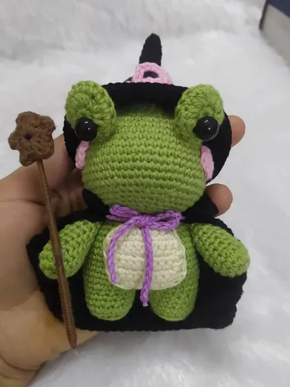 Holding the wizard frog to show his size. He's a handful of magic and cuteness.