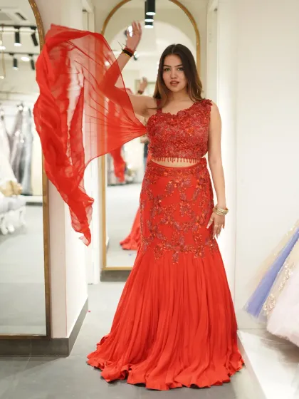 A full shot of the fiery red fish-cut lehenga, showing off the flowing dupatta and intricate beadwork on the blouse. It’s a look that’s full of passion and glamour.