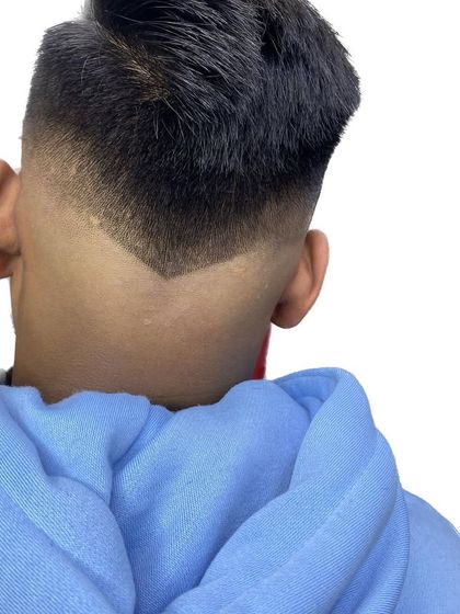 A close-up of a V-cut nape on a skin fade. The precision here is key to making the style stand out.