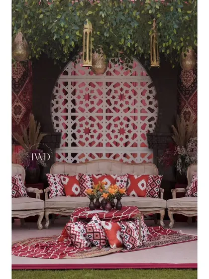 For this Mehendi, we created a 'Souk at Fatehpur' theme. The seating area featured rich textiles, traditional prints, and intricate lattice work, transporting guests to a Moroccan market.