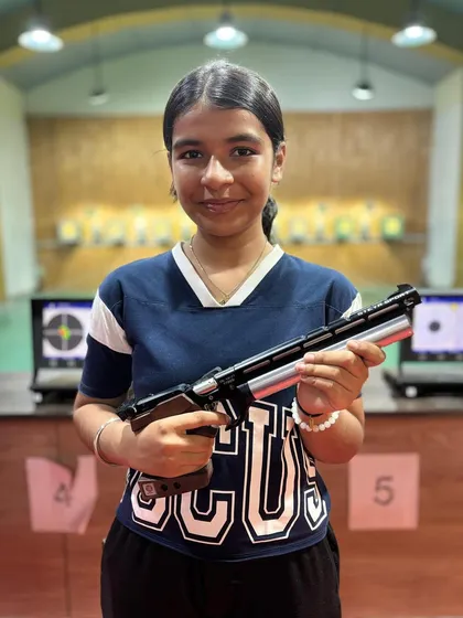 Pahel Jain with her air pistol after winning a gold medal at the 11th West Zone Competition.