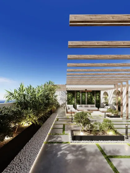 This angle emphasizes the landscaping along the edge of the terrace, with uplighting that highlights the plants and creates a beautiful border against the sky.