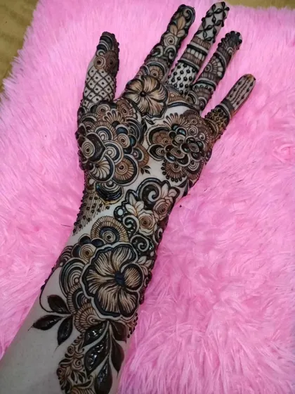 Another shot of the full-sleeve floral design, this time on a plush pink surface, highlighting its luxurious and celebratory feel.