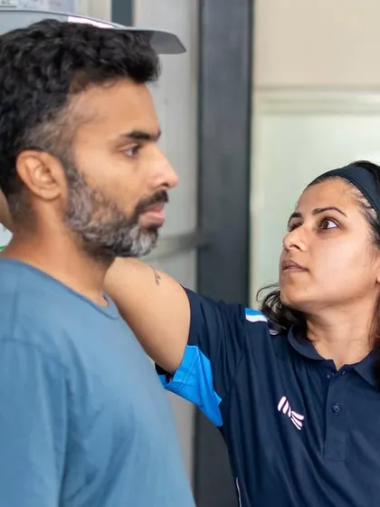 A coach measures an athlete's height at our Jayamahal center. This facility has become a community hub for youth athletes, clients returning from injury, and pros.