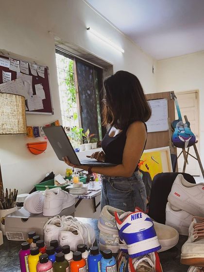 A candid shot of me working on my laptop in the studio. Every project starts here, with research and sketching out ideas before I present them to a client.
