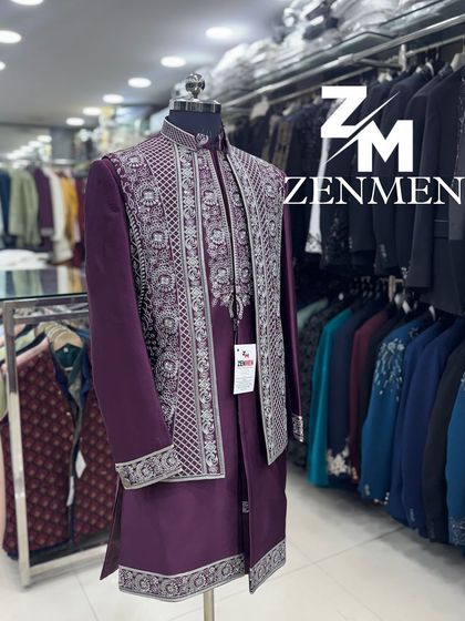 A side view of the wine-colored Indo-Western ensemble, showing the intricate embroidery on the jacket's hem and cuffs.