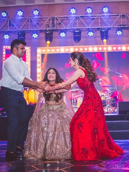 A beautiful moment of a brother and sister pulling their bride sister for a dance. This was a fun, spontaneous-looking act that captured the pure love between siblings.
