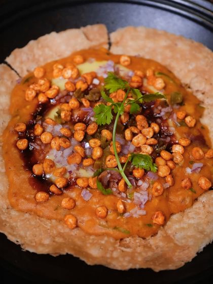 My version of Dal Pakwan. A crispy, large pakwan forms the base for hearty dal, topped with a zing of jalapeño and the crunch of kachumber.