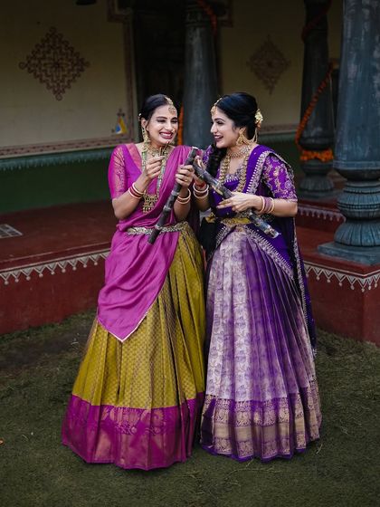 A full-length shot showcasing the beautiful traditional outfits against a rustic backdrop, perfect for capturing the spirit of Pongal or Sankranti.