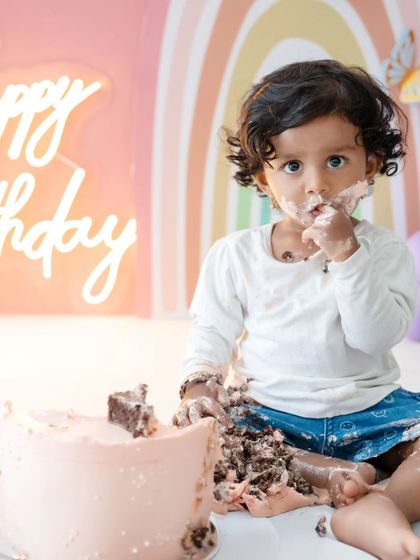 A close-up of the birthday girl's messy face as she enjoys her cake, a classic and cherished memory.