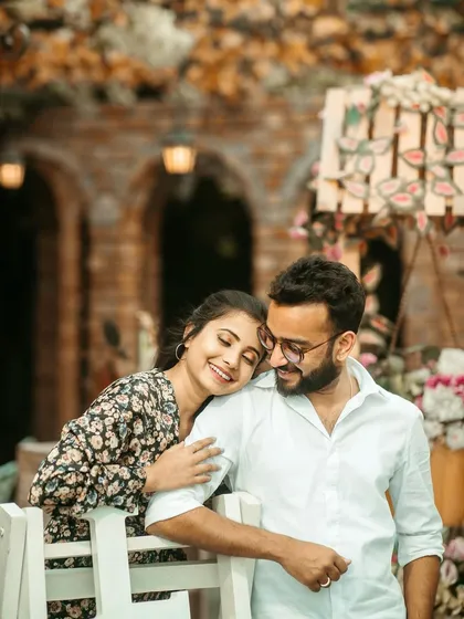 A romantic moment in a beautifully decorated setting. The makeup is soft and pretty, complementing the floral backdrop.