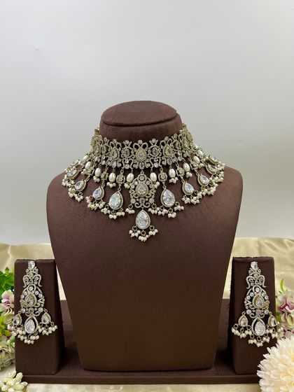 A close-up of the earrings from our all-white AD and pearl necklace set, highlighting the intricate craftsmanship.