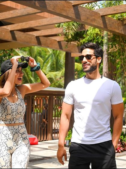A couple shares a playful moment with binoculars, ready for some bird watching or simply enjoying the views together during their romantic hideaway.