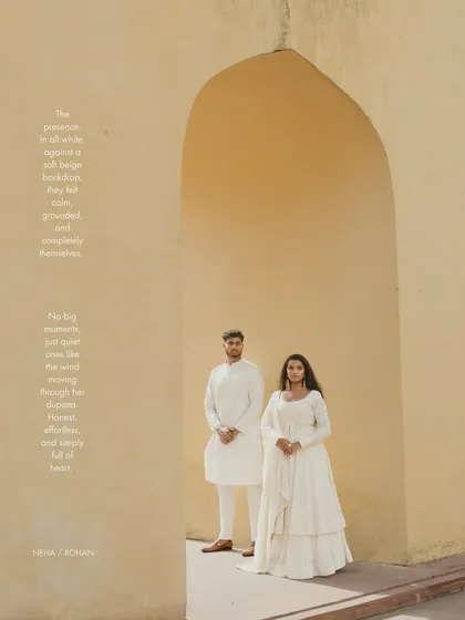 A classic portrait within a sandstone arch in Jaipur. The simplicity of the composition and the couple's coordinated white outfits create a serene and elegant pre-wedding photograph.